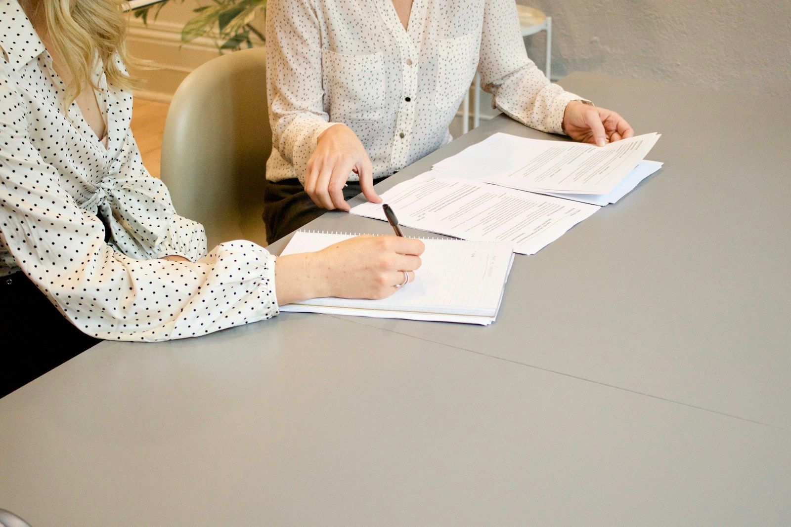 Two people reviewing paperwork together at a table